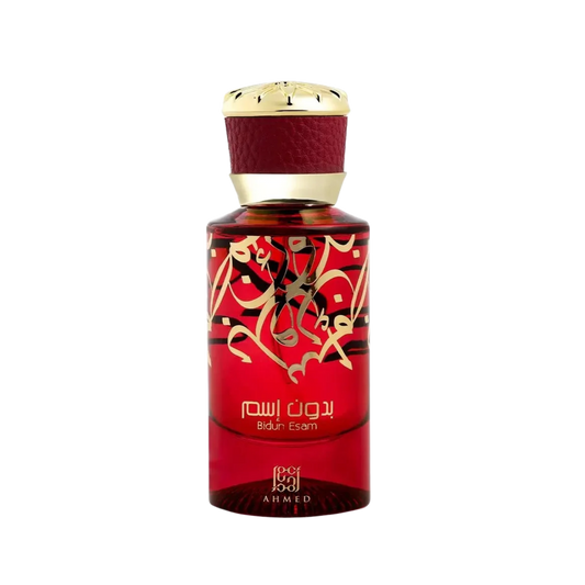 A bottle of Ahmed Ibn Al-Ahlia perfume with a deep red body, gold Arabic calligraphy, and a textured dark red neck with a gold cap, set against a plain white background.