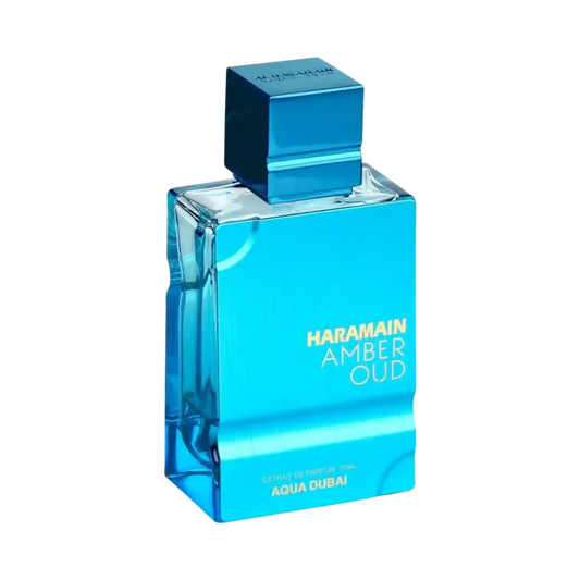 A rectangular glass perfume bottle with a metallic blue cap, labeled 'HARAMAIN AMBER OUD' and 'AQUA DUBAI', on a plain white background.