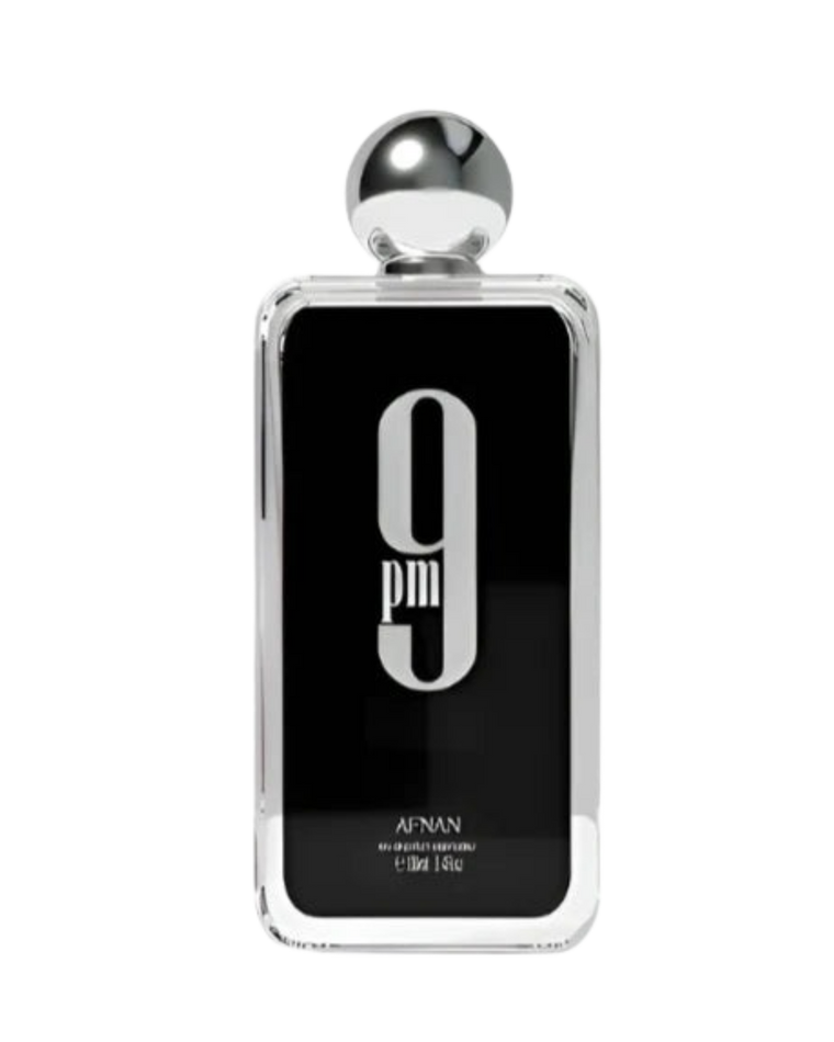 A rectangular perfume bottle with a glossy black front panel, silver metallic edges, a spherical silver cap, and the text '9 pm' and 'APNAN' visible on the bottle, set against a plain white background.