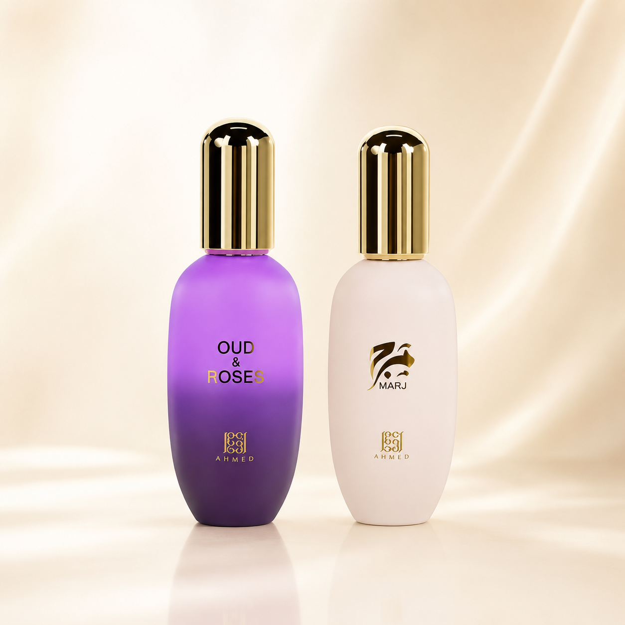 Two cosmetic bottles on a soft beige satin-like background. The left bottle is purple with a gold cap and reads 'OUD & ROSES' and 'AHMED'.