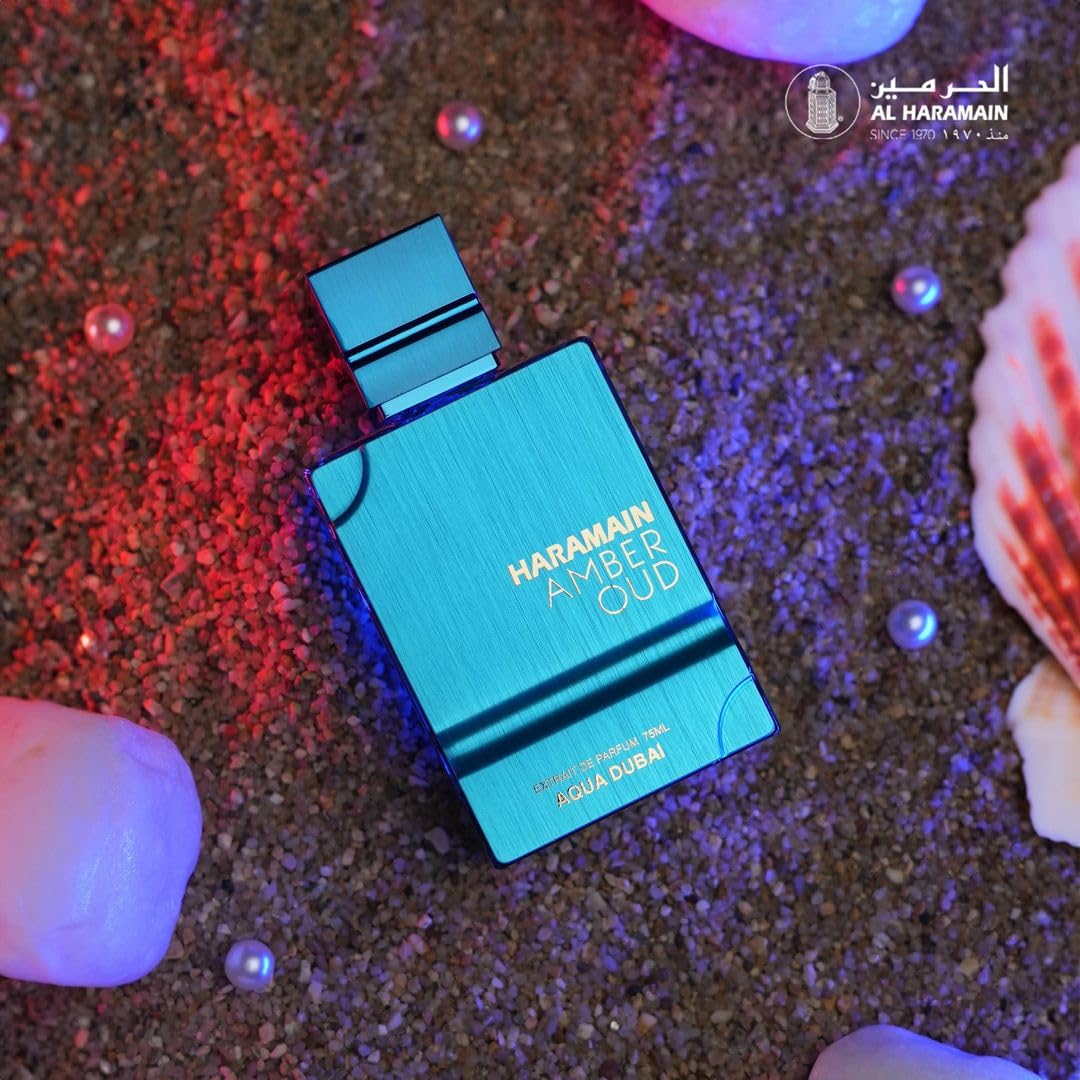 Blue Harrold Amber Oud perfume bottle on a textured surface with seashells.