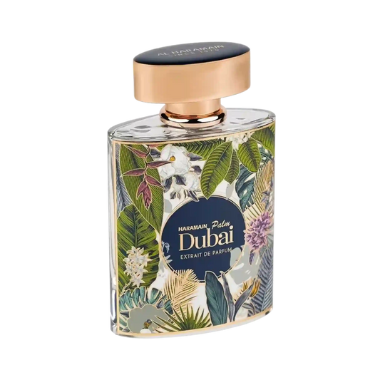 A rectangular glass perfume bottle for Al Haramain Palm Dubai, featuring a tropical floral and leaf pattern in green, beige, and purple, with a metallic rose gold cap and a dark navy blue label.