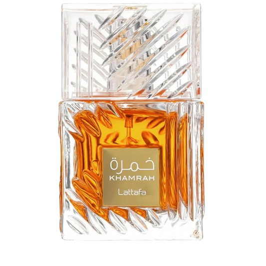 A clear glass perfume bottle with a faceted, geometric transparent cap and a gold label reading 'Khamrah Lattafa' in white text. The bottle is filled with amber-orange liquid and photographed on a plain white background.