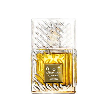 A rectangular glass perfume bottle with a faceted, textured clear cap and base, filled with rich amber-yellow liquid. A gold label on the front reads 'KHAMRAH QAHWA Lattafa' in white text.