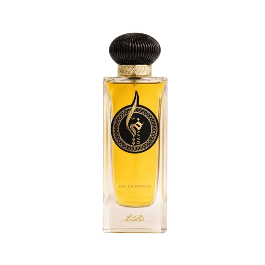 A rectangular glass perfume bottle filled with golden-yellow liquid, featuring a black ribbed cap, a gold band, and a black circular label with a stylized emblem. The text 'EAU DE PARFUM' is visible near the bottom, along with Arabic script.