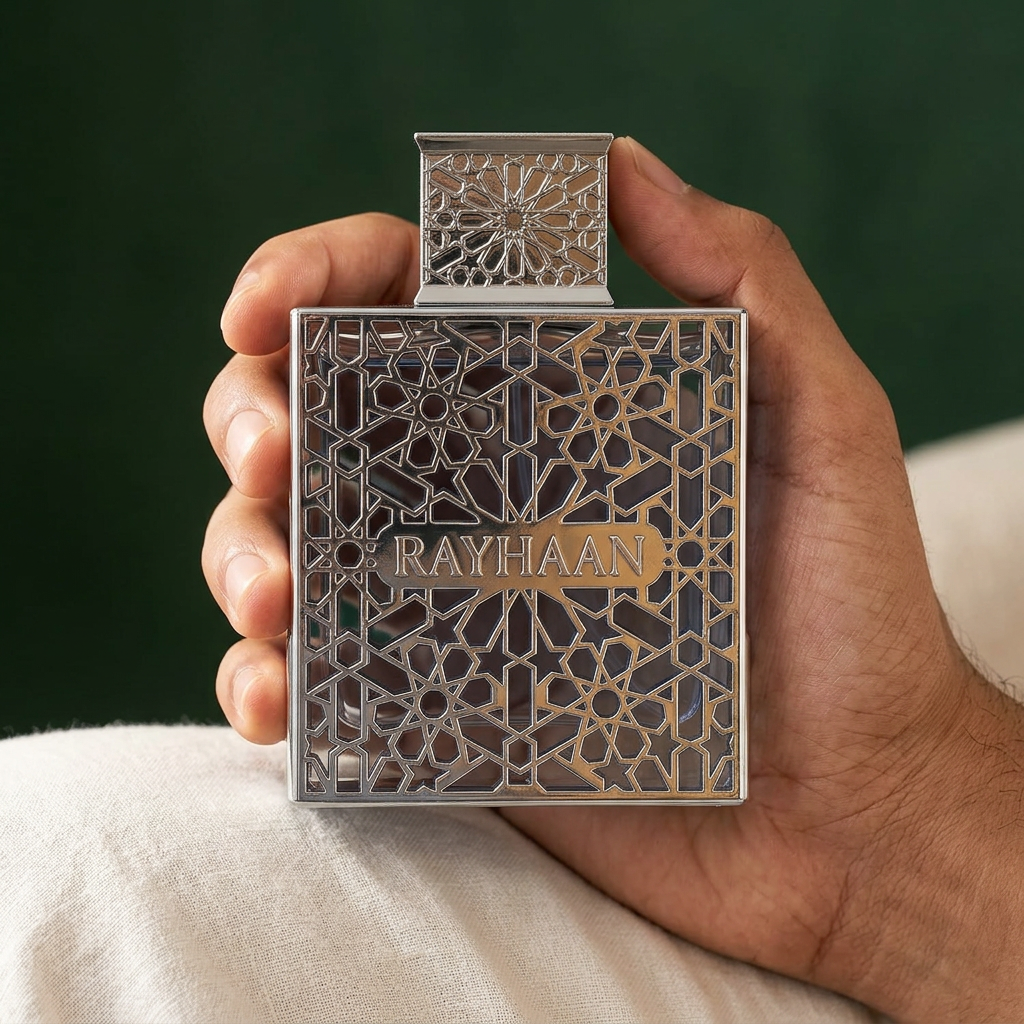 Rayhaan Aquatica 100ml perfume bottle held in one hand against ivory linen and a forest-green background.