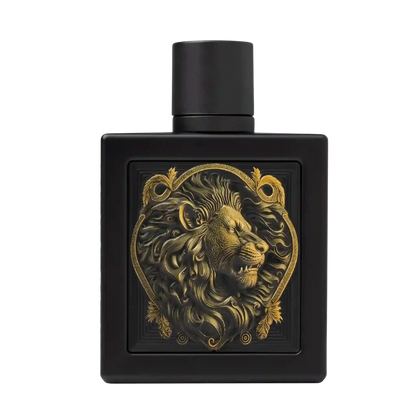 A matte black rectangular perfume bottle with a cylindrical cap, featuring a raised gold lion head emblem inside an ornate heart-shaped border on the front.